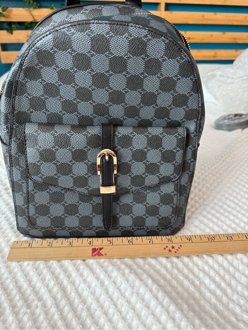 Compact Gray-Black Backpack with Gold Hardware